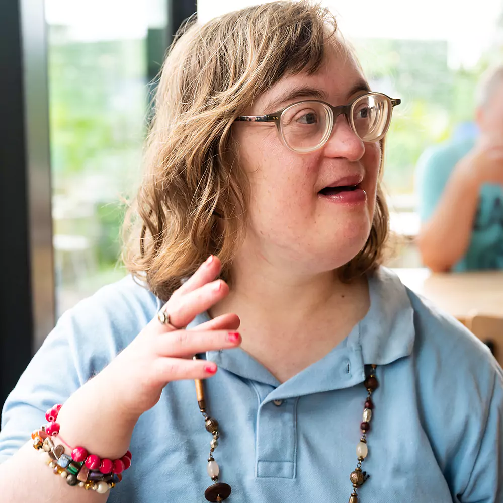 A down syndrome woman in a cafe ordering food